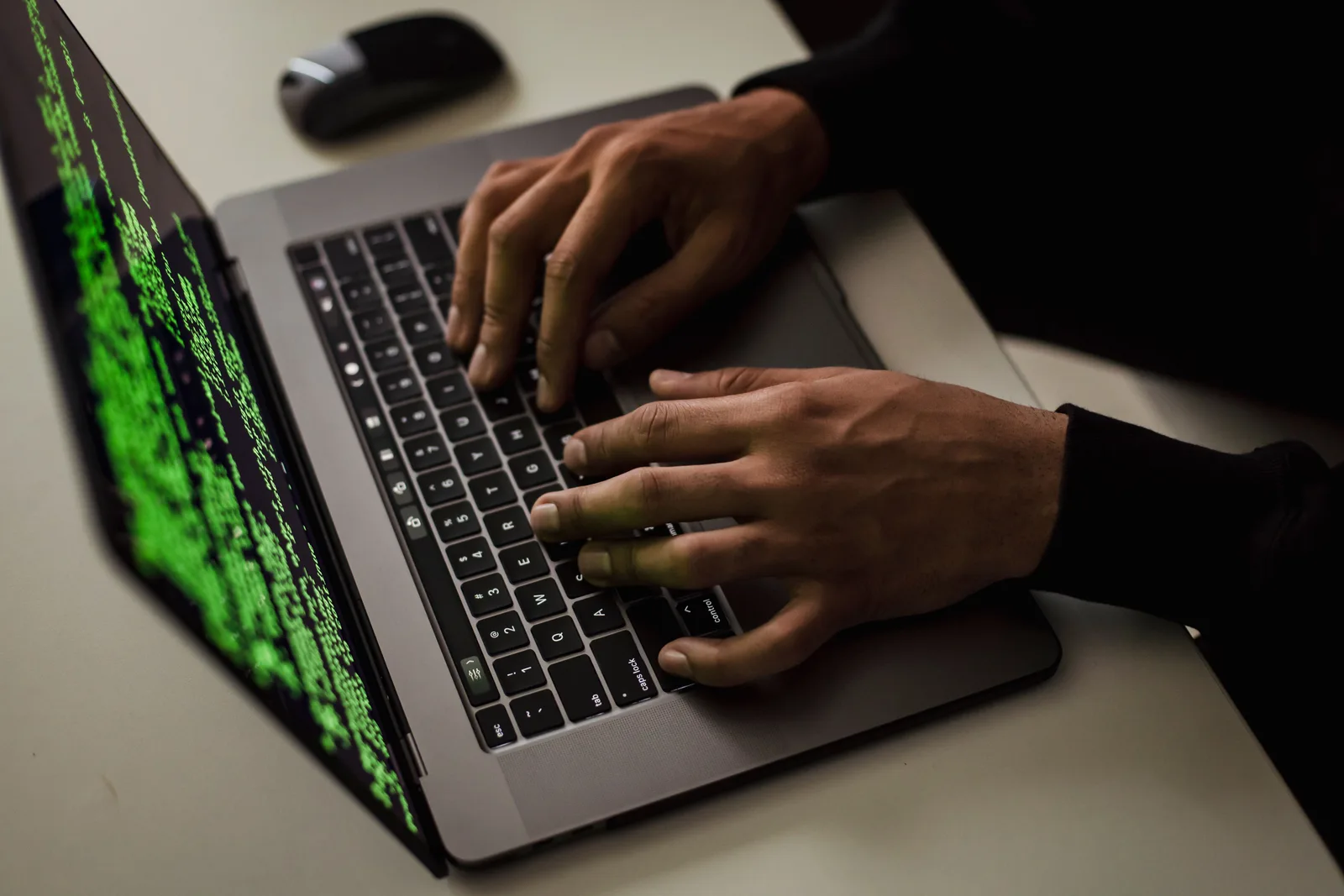From above of crop anonymous male hacker typing on netbook with data on screen while sitting at desk. How to decide what a phishing message actually wants from you