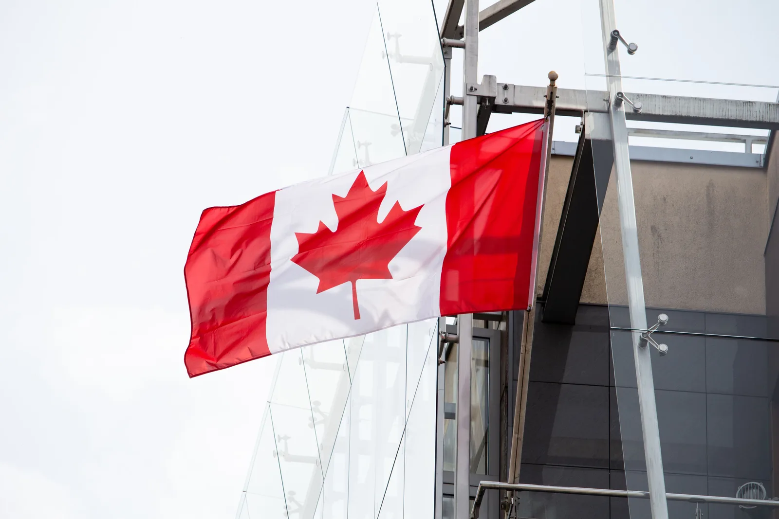A vibrant Canadian flag waving on a clear day, representing patriotism and national pride. Phishing scams policy template with the blanks filled in