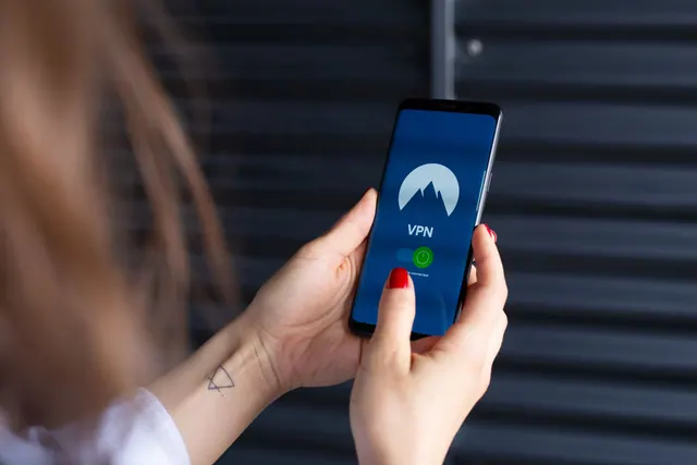 Close-up of a woman's hands using a VPN app on a smartphone, emphasizing digital security. How to approach best privacy settings tools in practice