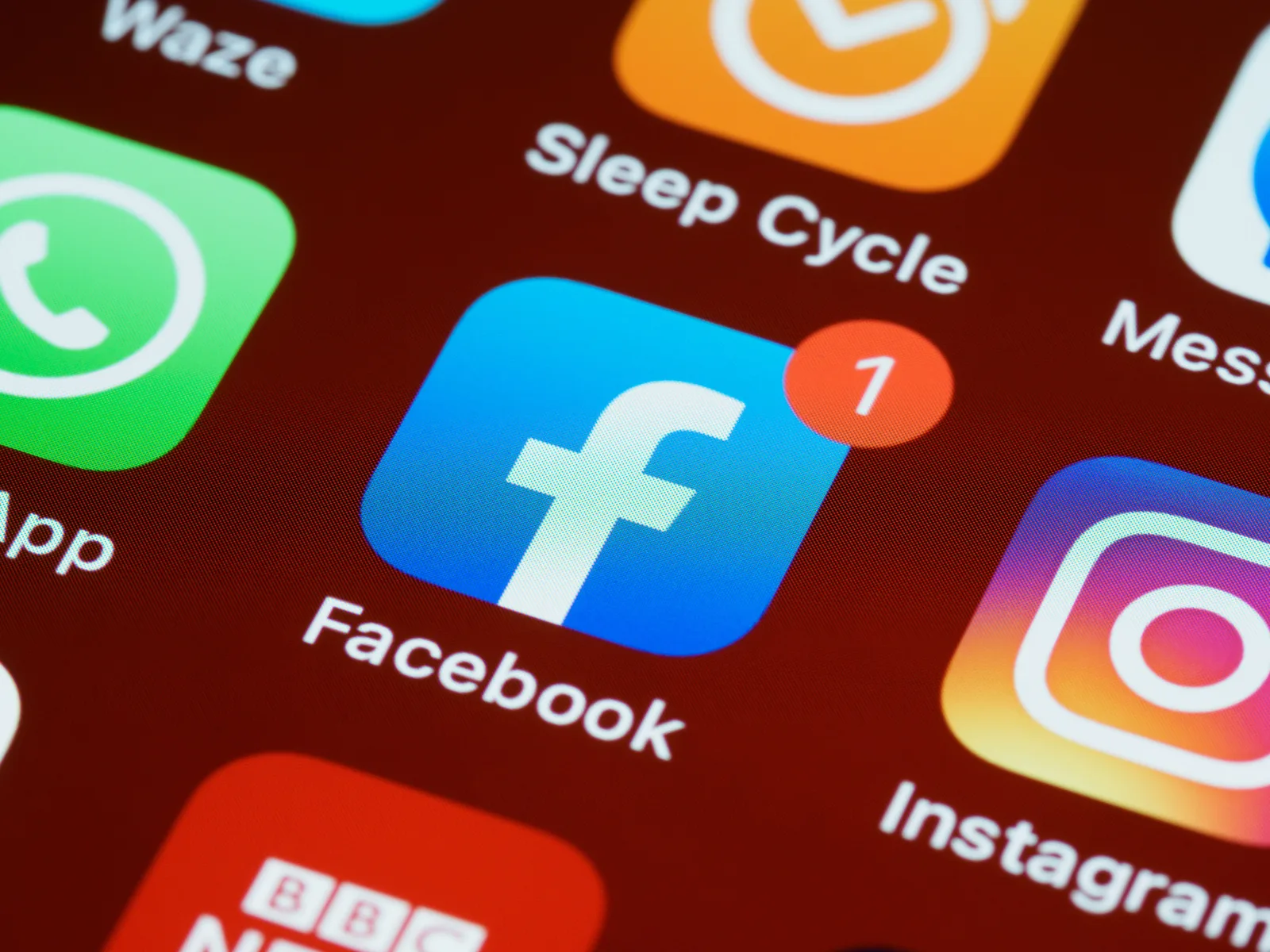 A detailed close-up of social media app icons on a smartphone screen. Five ways a platform redesign affects your privacy settings and how to check